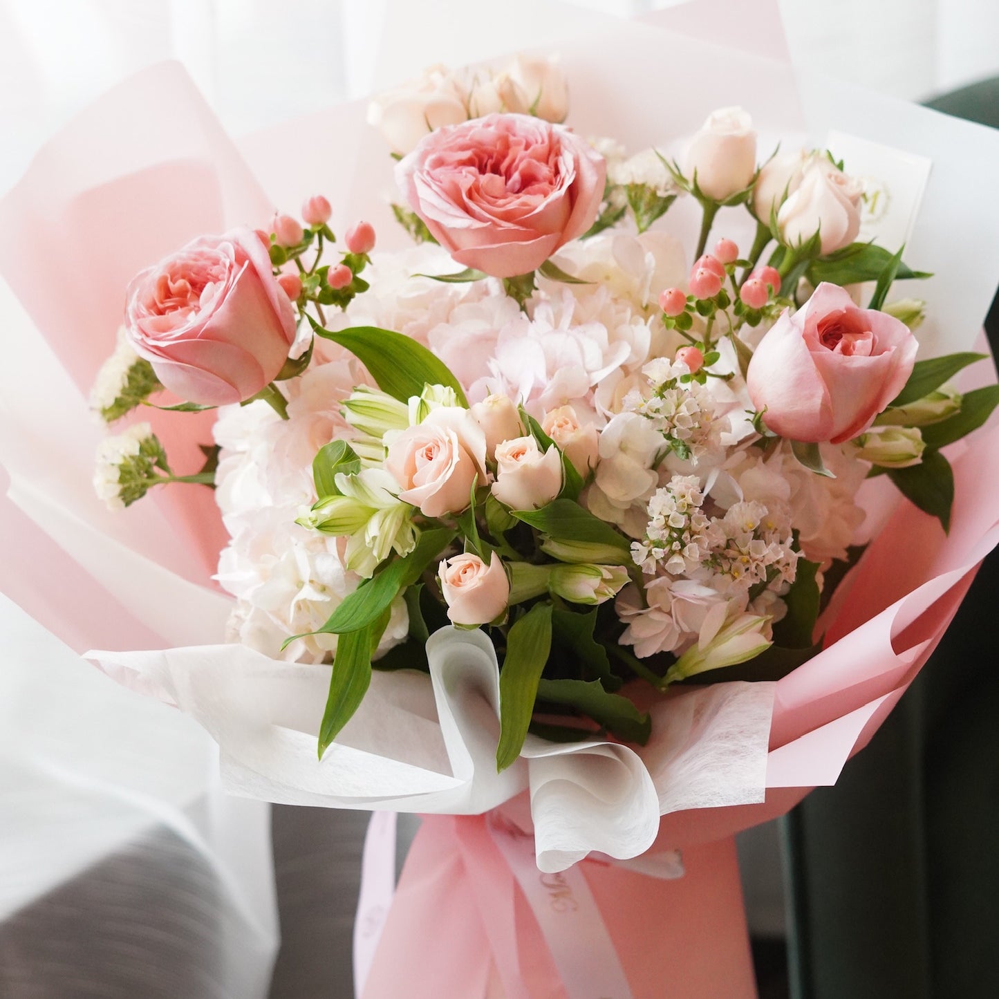 ​Elegant pink rose,hypericum berry and hydrangea bouquet in soft pink wrapping for Mother's Day flower delivery in Toronto.