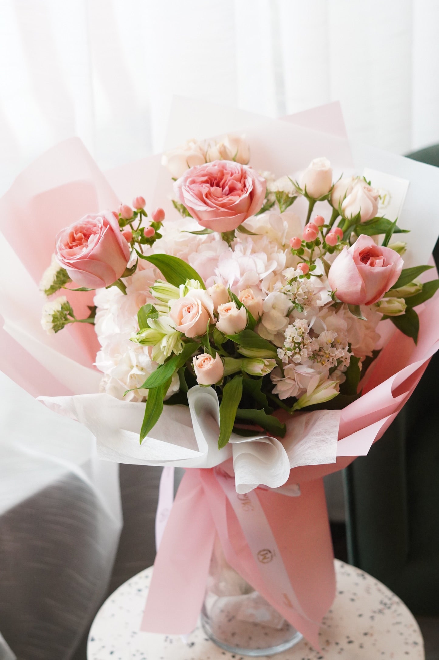 ​Elegant pink rose,hypericum berry and hydrangea bouquet in soft pink wrapping for Mother's Day flower delivery in Toronto.