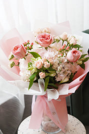 ​Elegant pink rose,hypericum berry and hydrangea bouquet in soft pink wrapping for Mother's Day flower delivery in Toronto.
