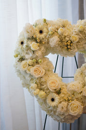 Everlasting Love white heart funeral wreath on a standing easel for same-day flower delivery in Toronto.