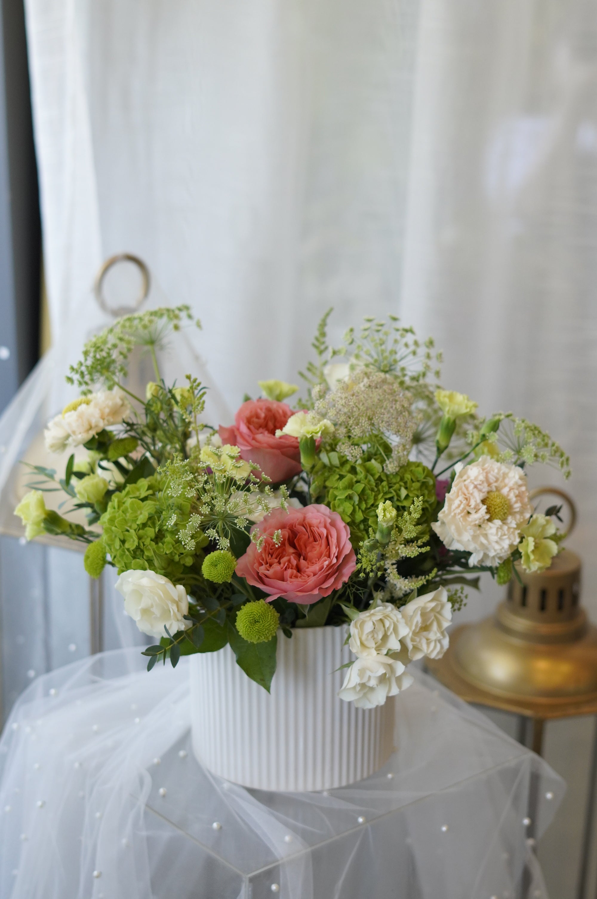 Fresh coral rose and green hydrangea dining table centerpiece designed for modern home décor and local flower delivery in Oakville and Toronto.