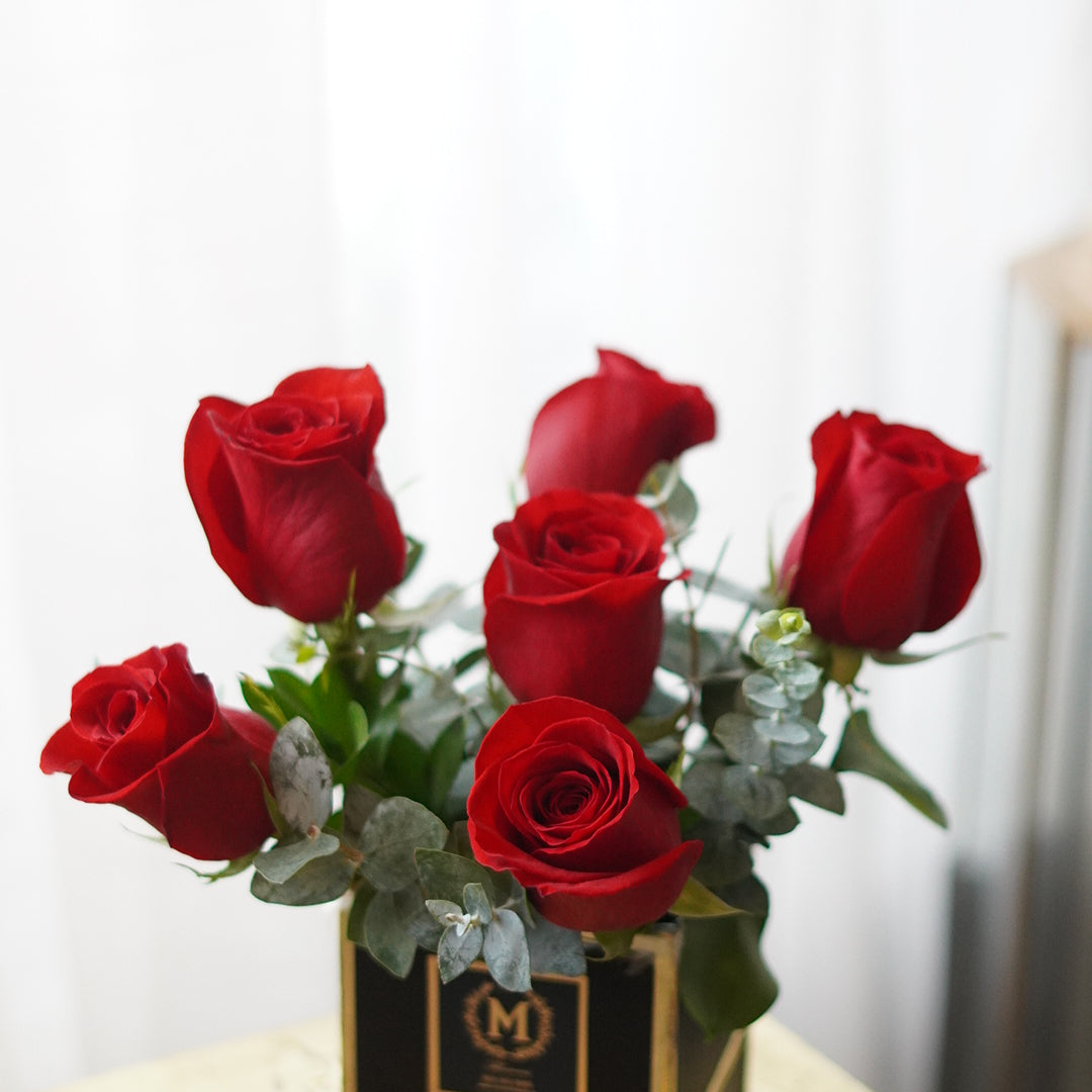 Close-up of half dozen rose box showing rose detail and box texture