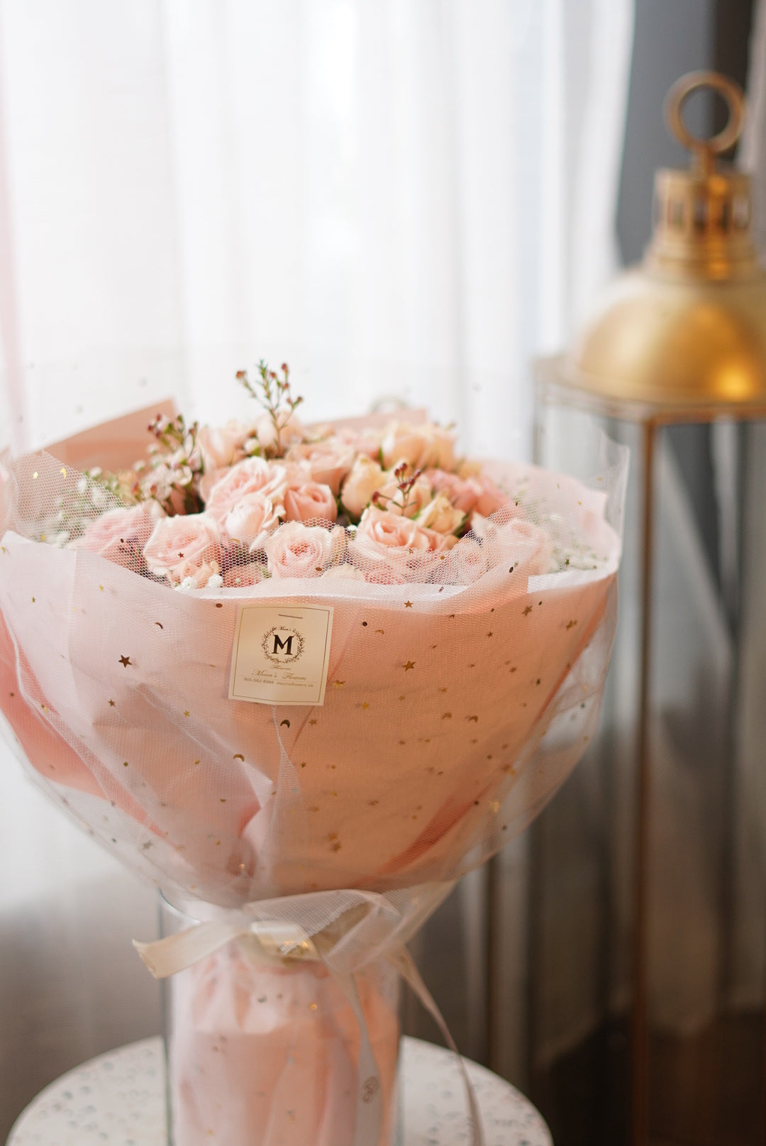 Hand-held Mother's Day Princess Bouquet featuring a lush arrangement of blush pink spray roses and baby's breath. High-quality florist-designed gift wrap by Moon's Flowers, perfect for same-day delivery in Toronto