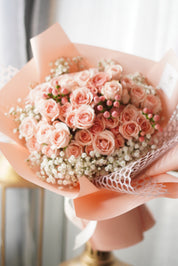 Hand-held pink spray rose bouquet with baby’s breath, romantic florist bouquet by Moon’s Flowers