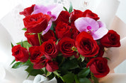 Hand-tied red rose bouquet with orchid in modern romantic style