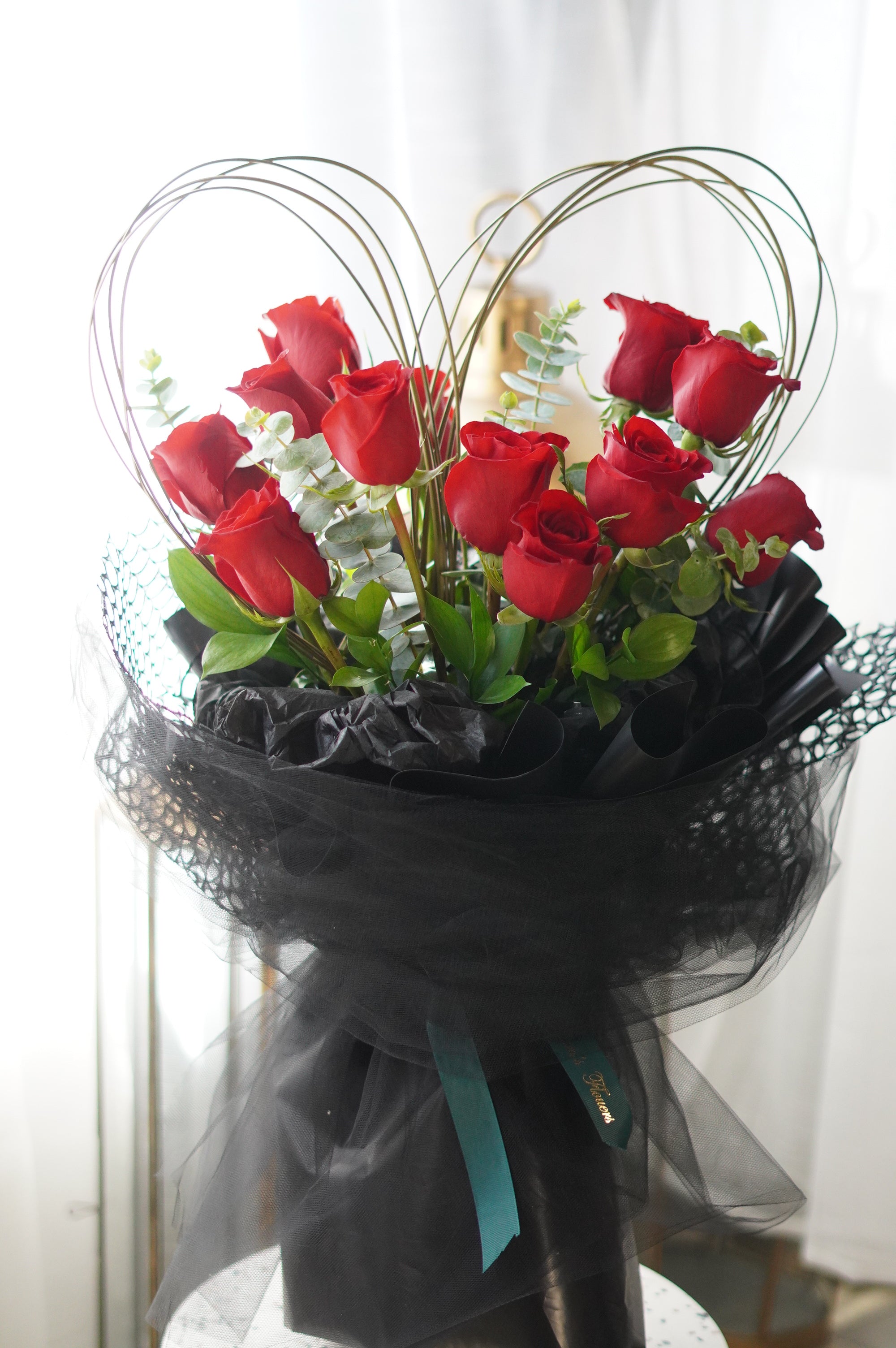 Heart-shaped red rose bouquet arranged in a defined heart design