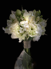 elegant white bridal bouquet with lisianthus and ranunculus close up