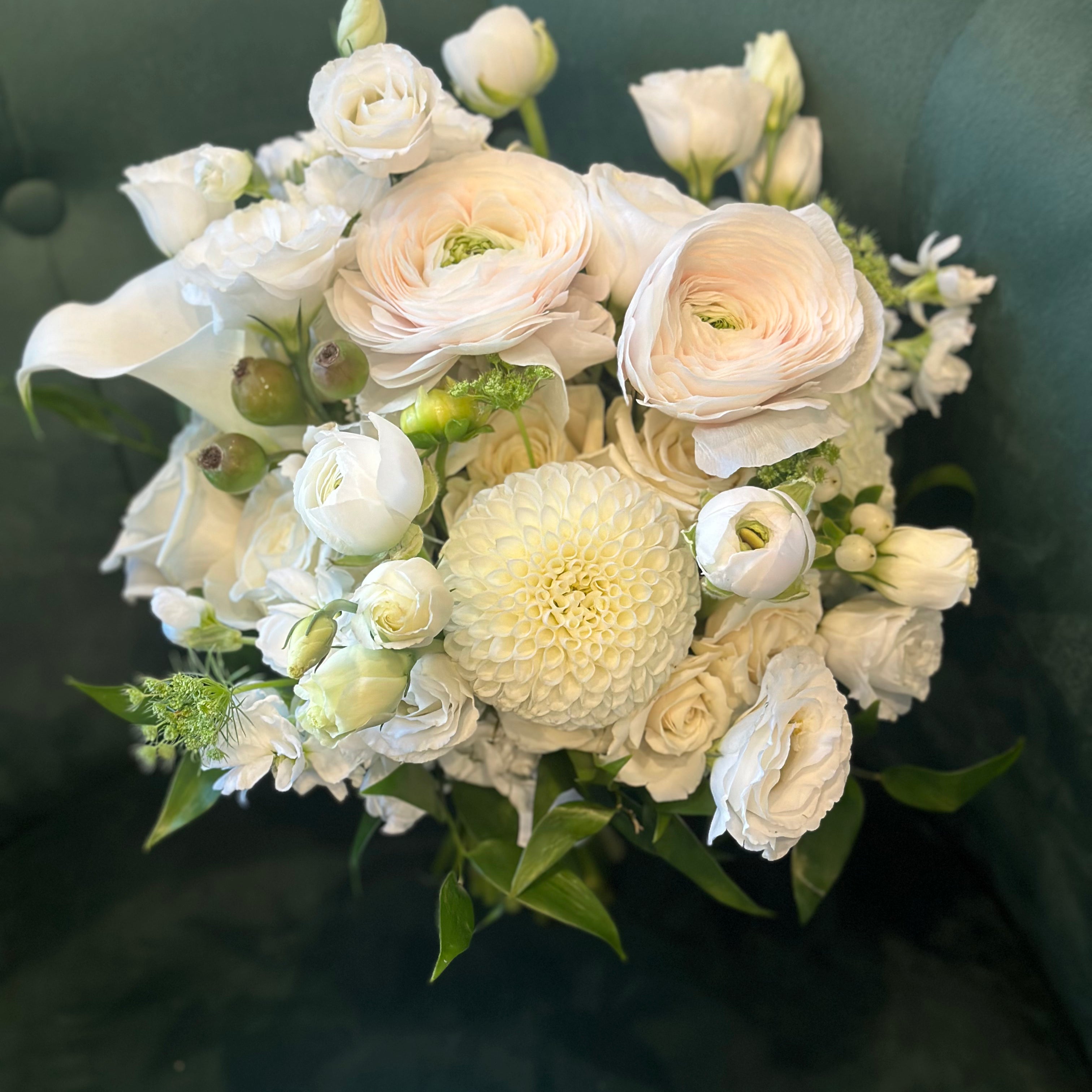 classic white wedding bouquet with ranunculus and roses bride holding bouquet