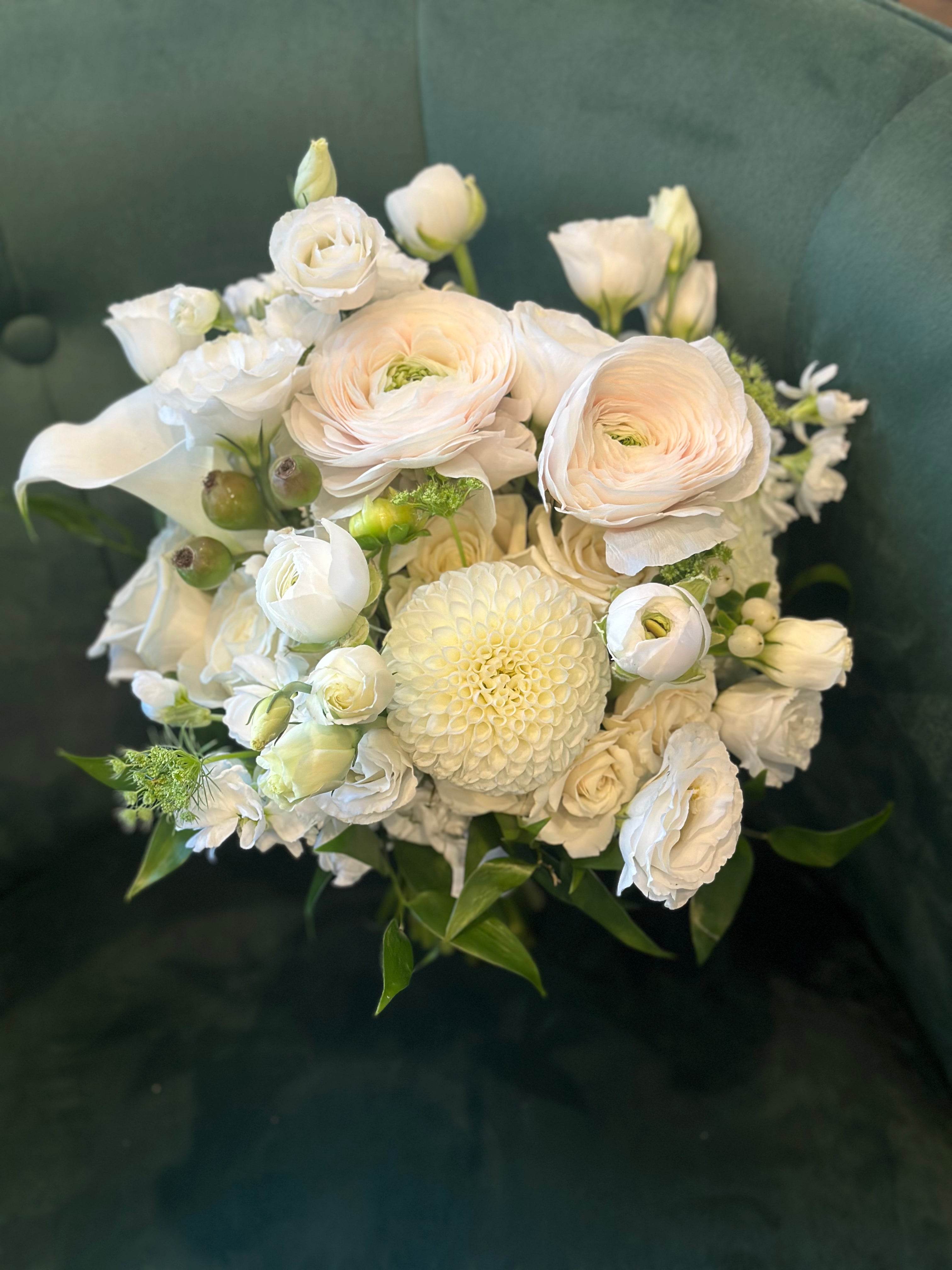 classic white wedding bouquet with ranunculus and roses bride holding bouquet