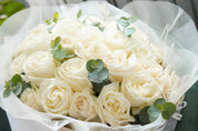 Close-up of Playa Blanca white roses in a round bouquet arrangement