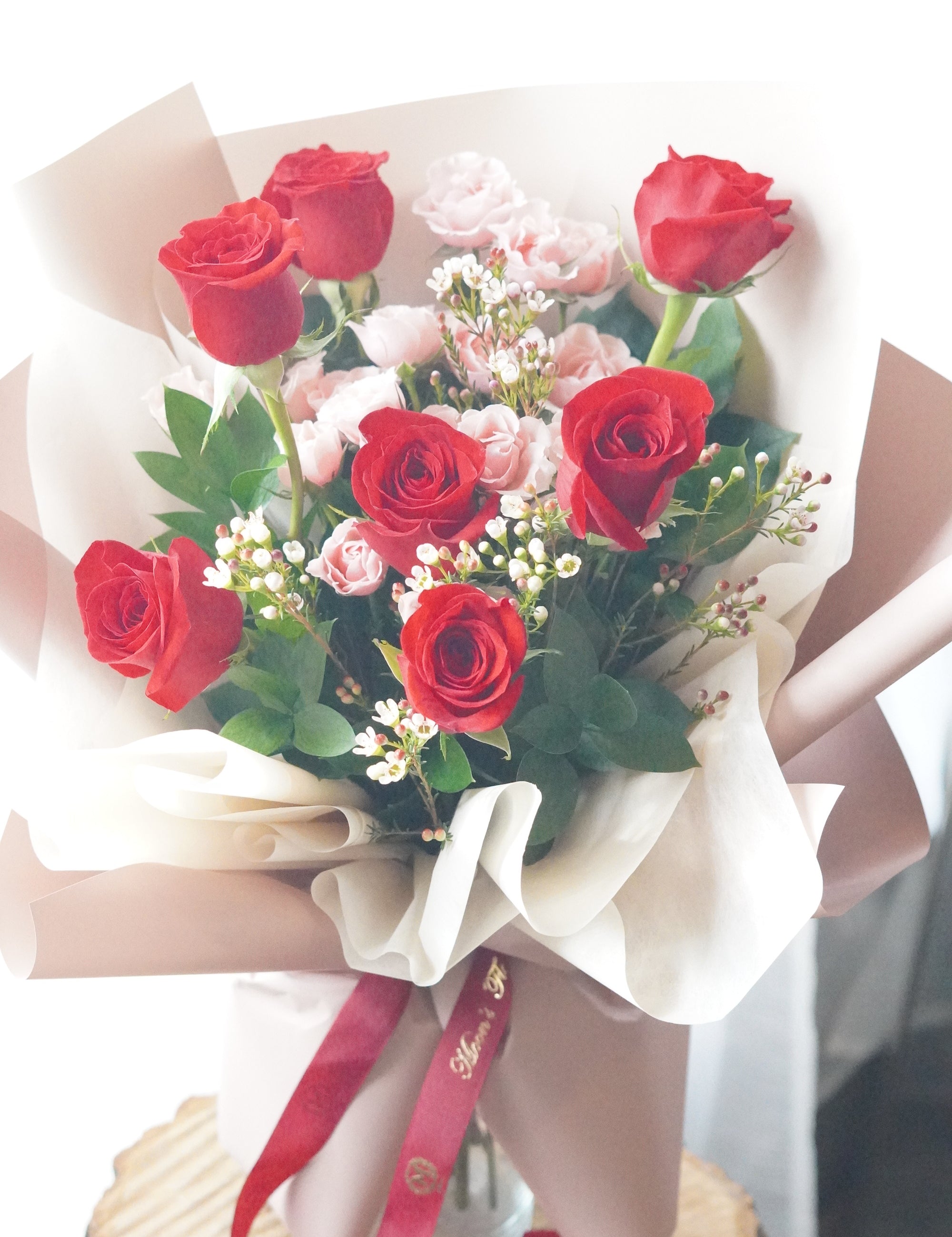 Strawberry Milk Roses bouquet with red roses, pink spray roses, waxflower, and fresh greenery