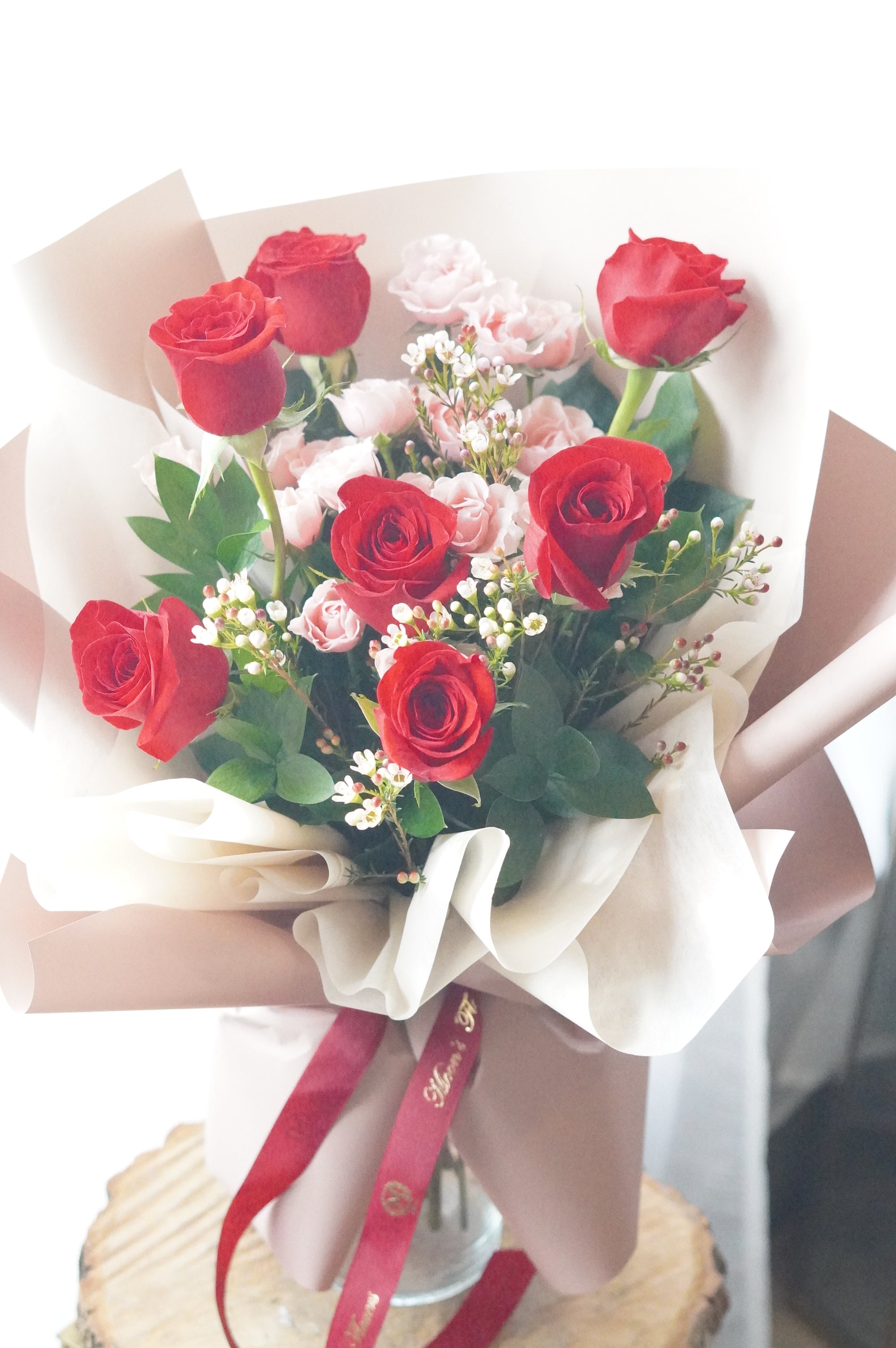 Strawberry Milk Roses bouquet with red roses, pink spray roses, waxflower, and fresh greenery