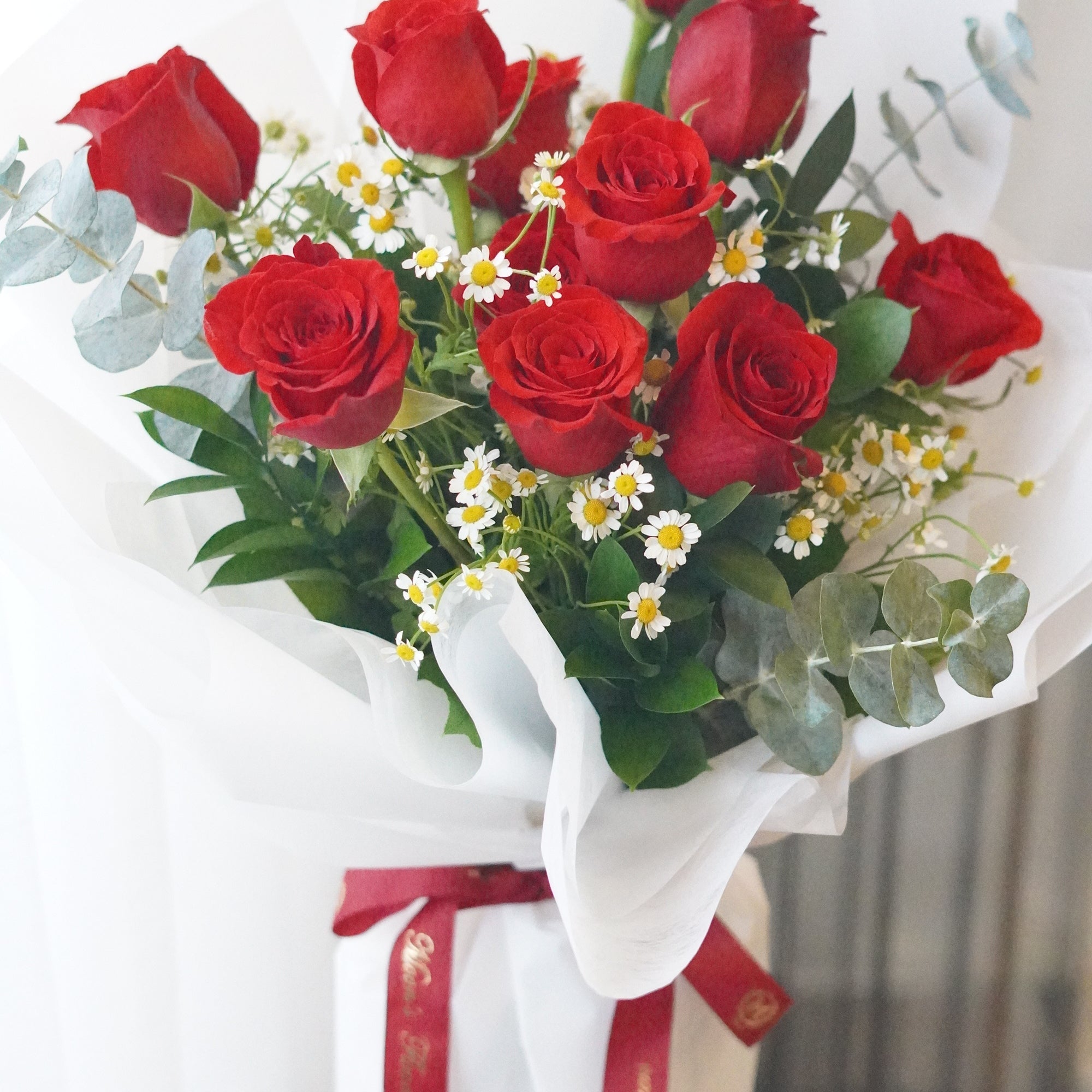 Rose in the Garden bouquet featuring dozen red roses with chamomile and fresh greenery