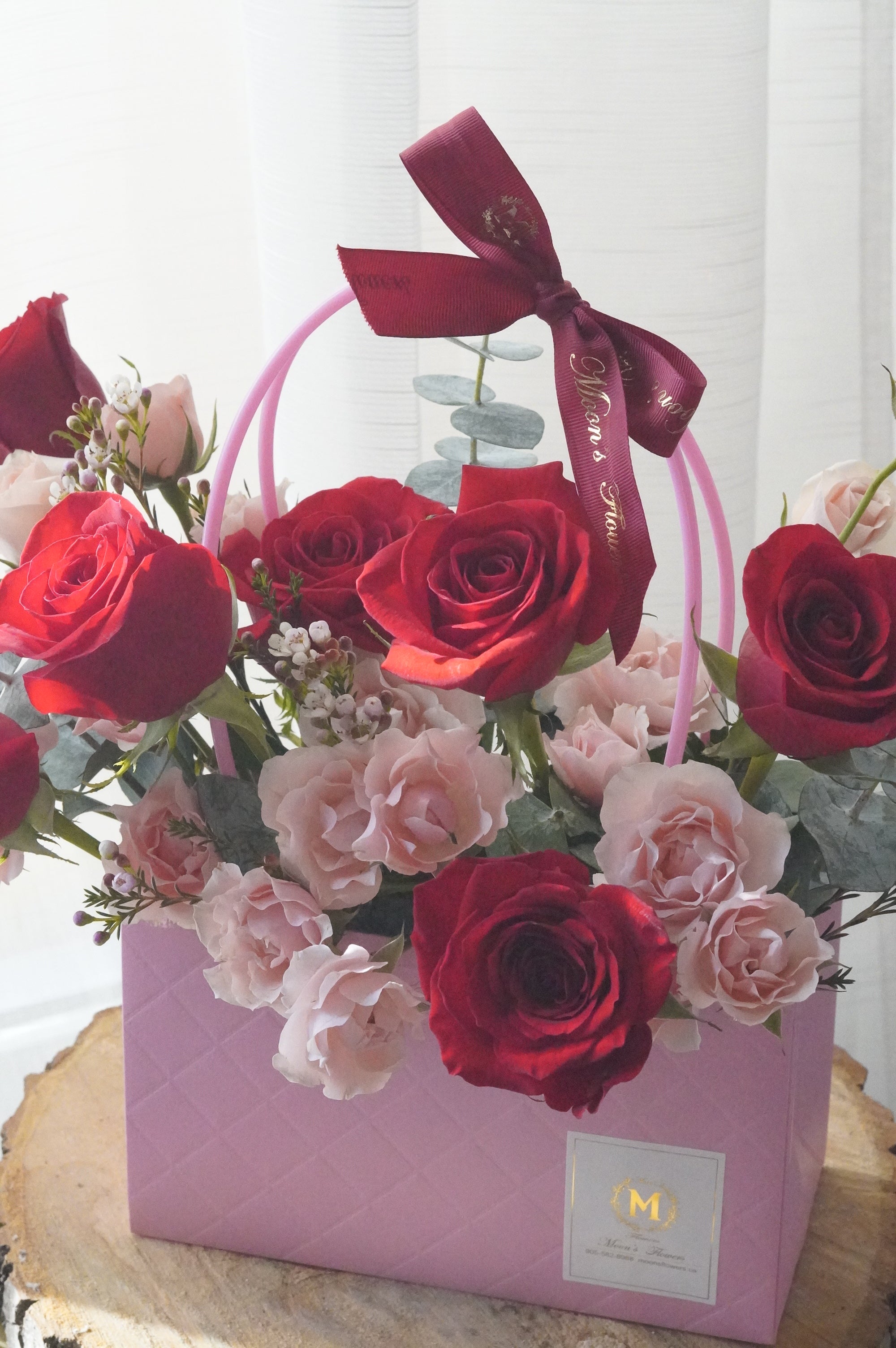 Close-up of red and blush roses with spray roses highlighting color contrast and floral detail