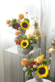 Close-up of sunflower, peach dahlias, rust-red blooms and green dianthus