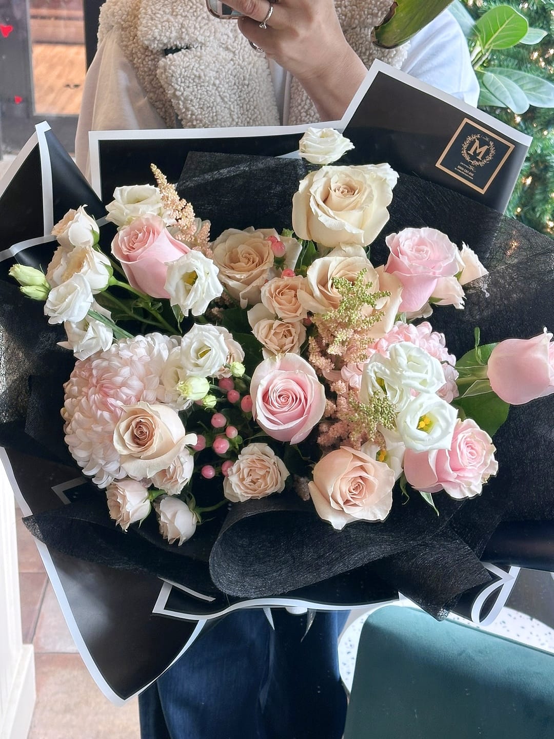 Luxury Mother's Day Signature bouquet featuring premium creamy white and soft pink roses in a chic black designer wrap. Hand-tied floral arrangement by Moon's Flowers, available for same-day delivery in Toronto and the GTA