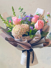 Luxury Pink Violet Mother's Day flower bouquet with premium pink and purple roses in designer paper wrap.