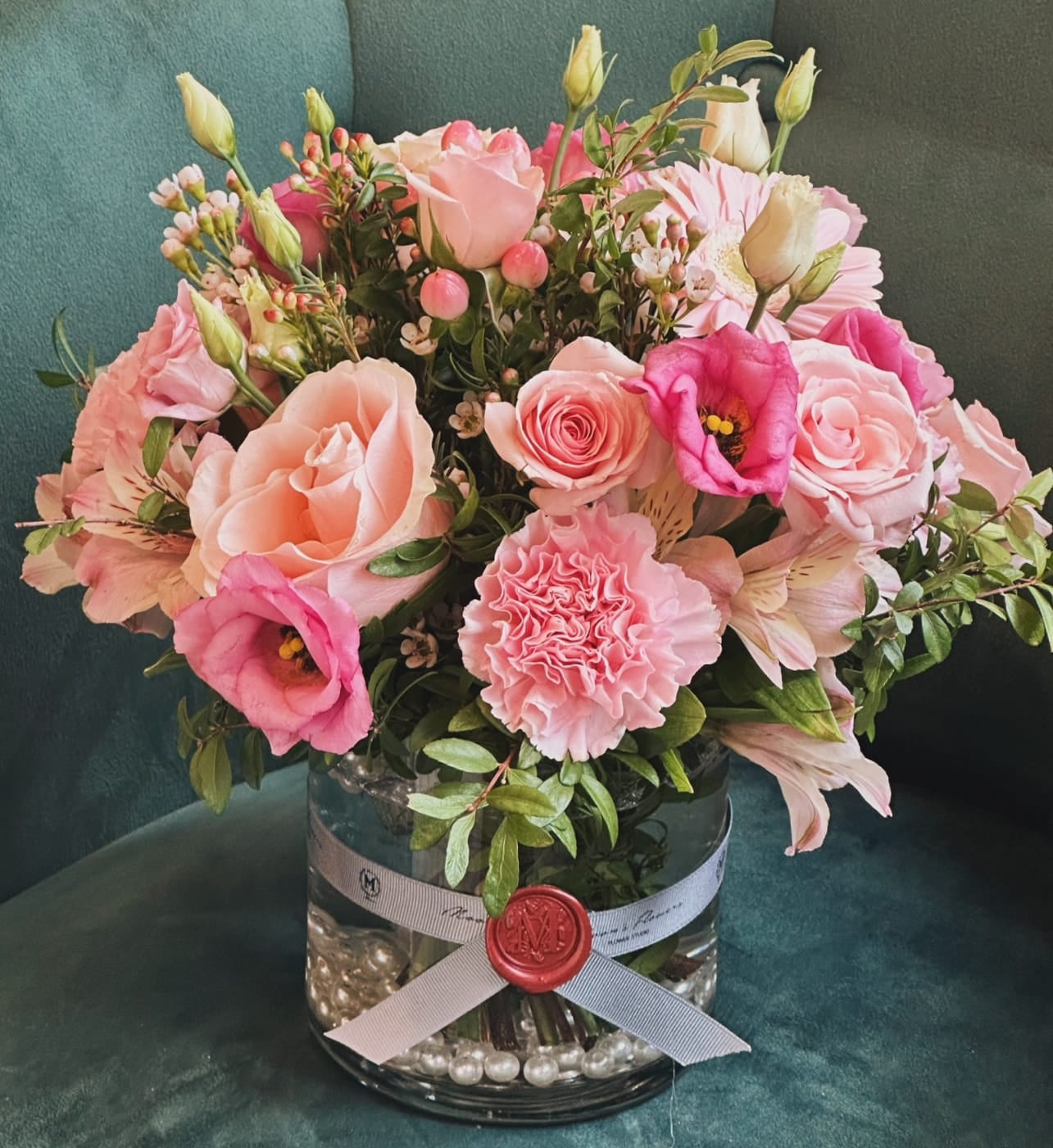 "Luxury pink rose bouquet for Mother's Day, professionally arranged in a glass vase with a signature seal