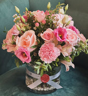 "Luxury pink rose bouquet for Mother's Day, professionally arranged in a glass vase with a signature seal