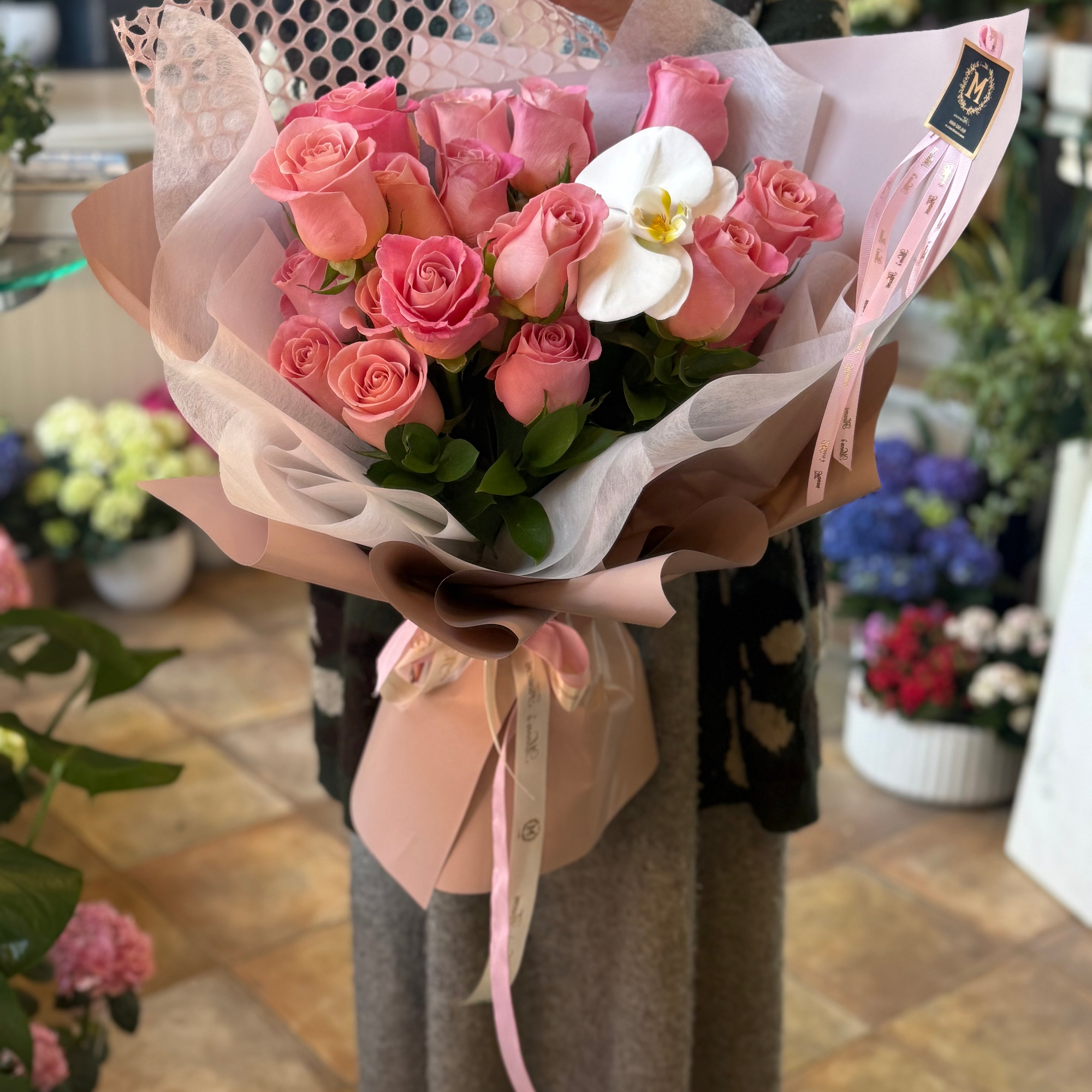 Luxury pink roses with velvety petals and white orchid accent