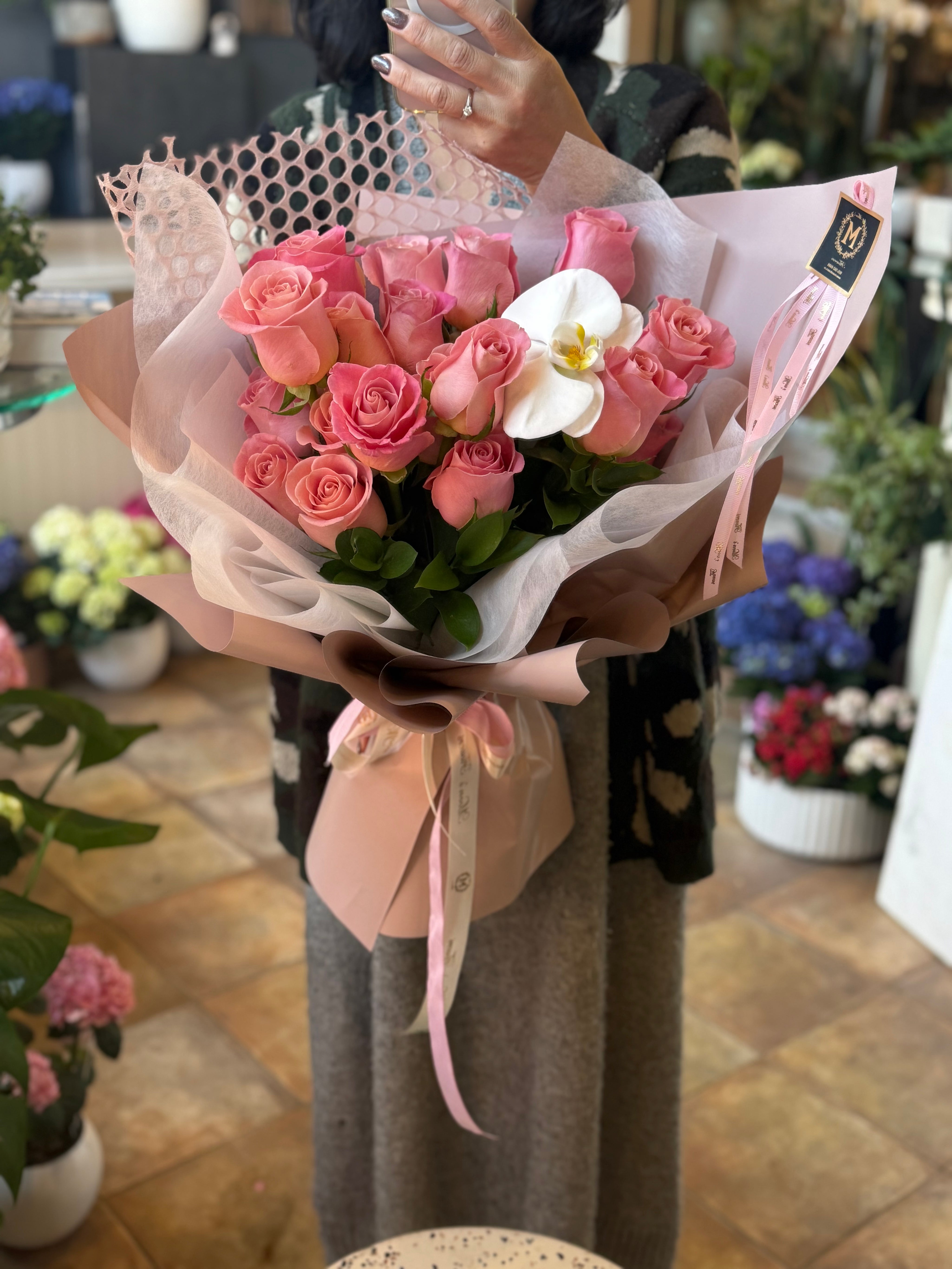Luxury pink roses with velvety petals and white orchid accent