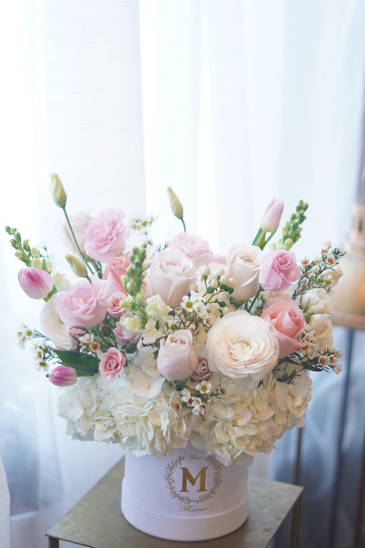 Moon’s Flowers signature hat box with blush and ivory flower arrangement