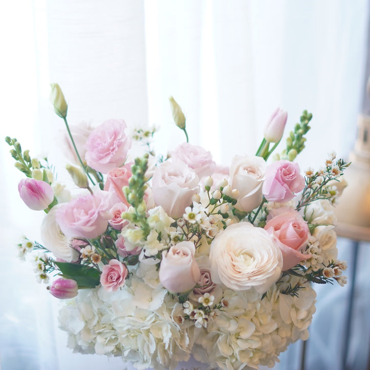 Moon’s Flowers signature hat box with blush and ivory flower arrangement