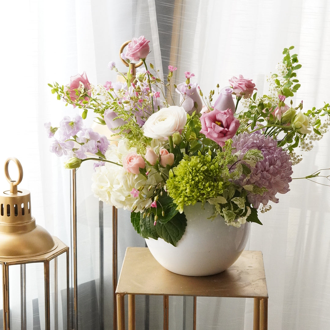 Pastel spring flower arrangement  with ranunculus and anemones. Luxury boutique flower delivery Toronto  and Oakville. Elegant table centerpiece for wedding and special events by Moon's flowers