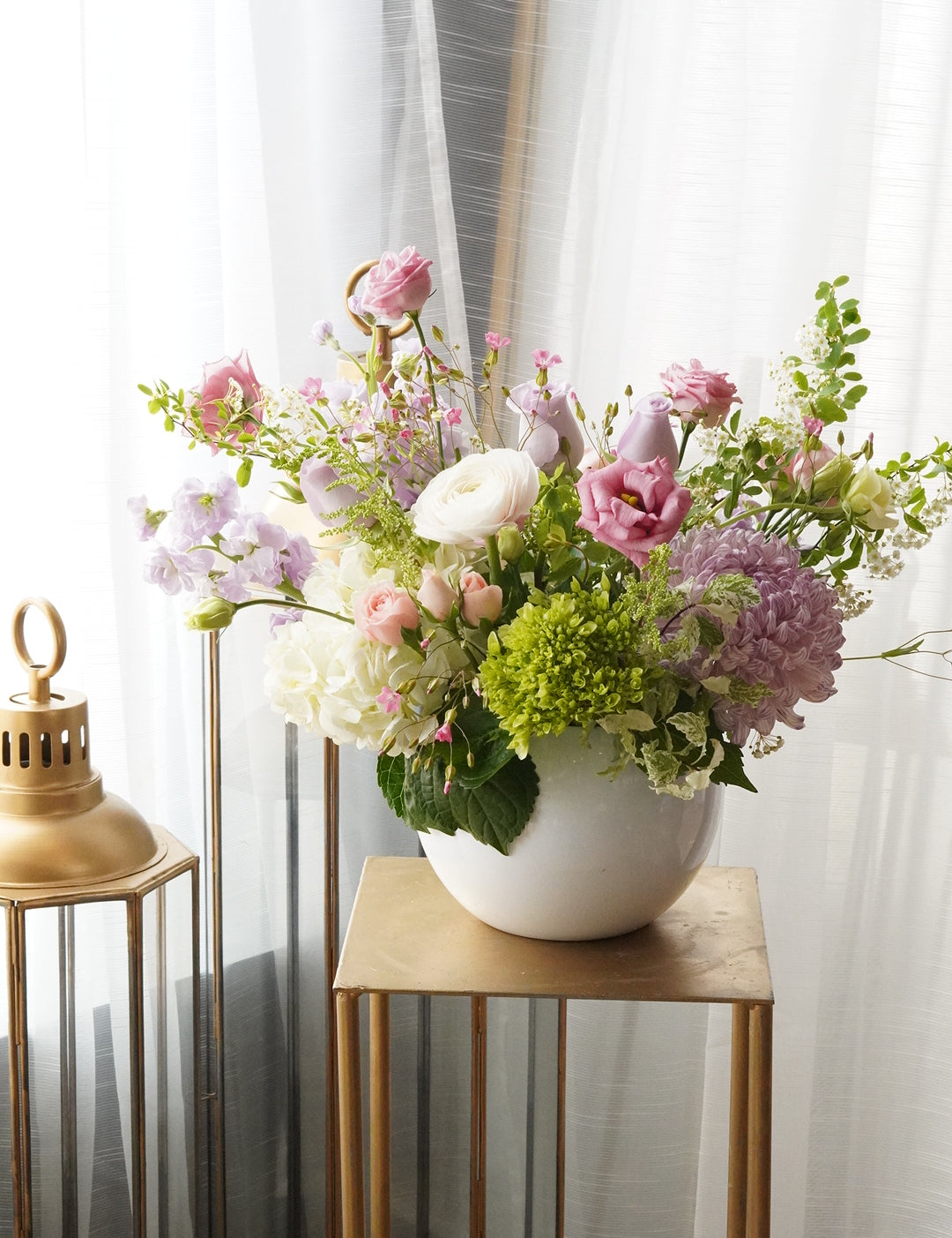 Pastel spring flower arrangement  with ranunculus and anemones. Luxury boutique flower delivery Toronto  and Oakville. Elegant table centerpiece for wedding and special events by Moon's flowers