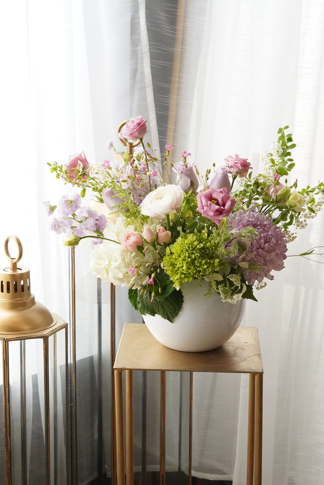 Pastel spring flower arrangement  with ranunculus and anemones. Luxury boutique flower delivery Toronto  and Oakville. Elegant table centerpiece for wedding and special events by Moon's flowers