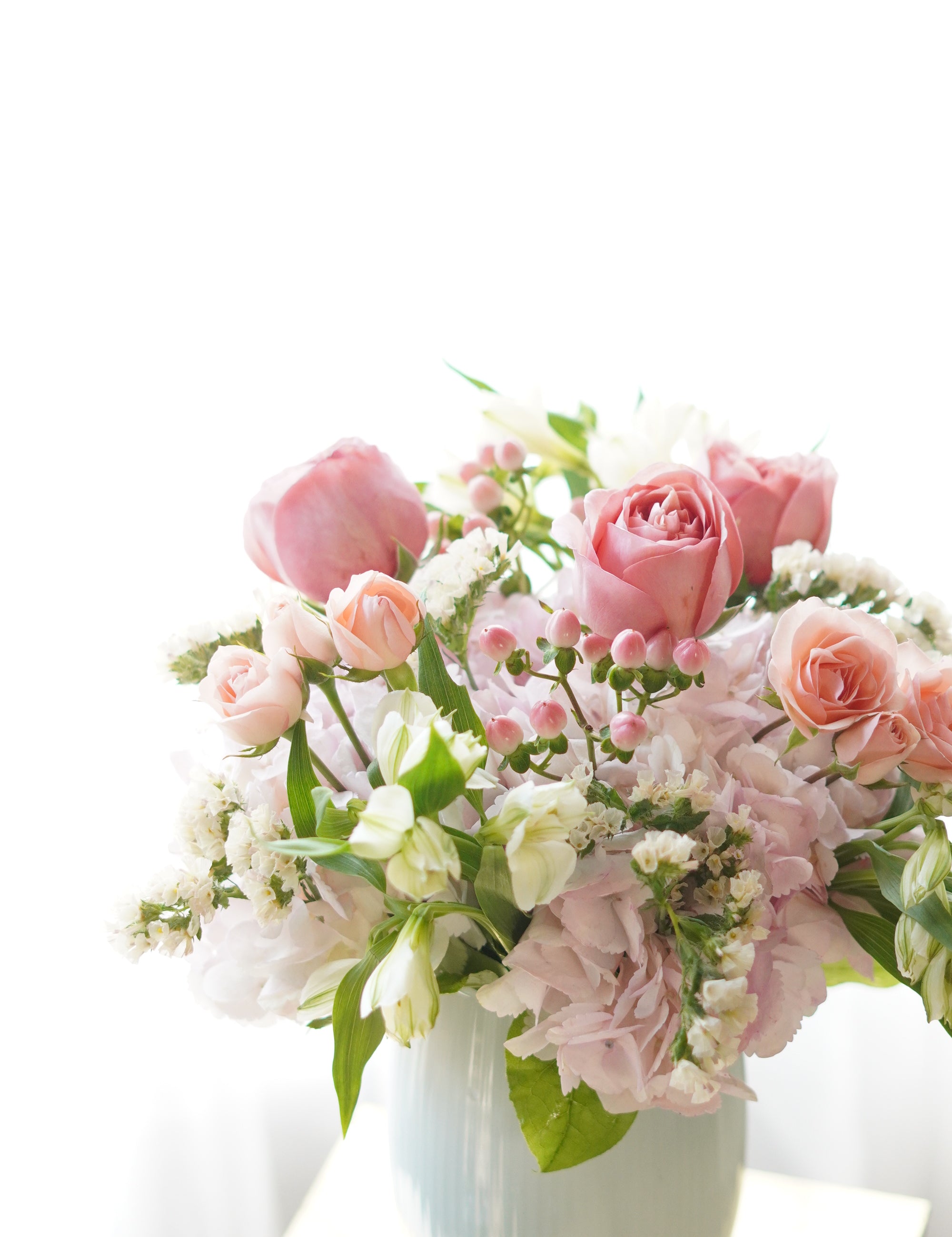 Bouquet of pink and white flowers on a white background