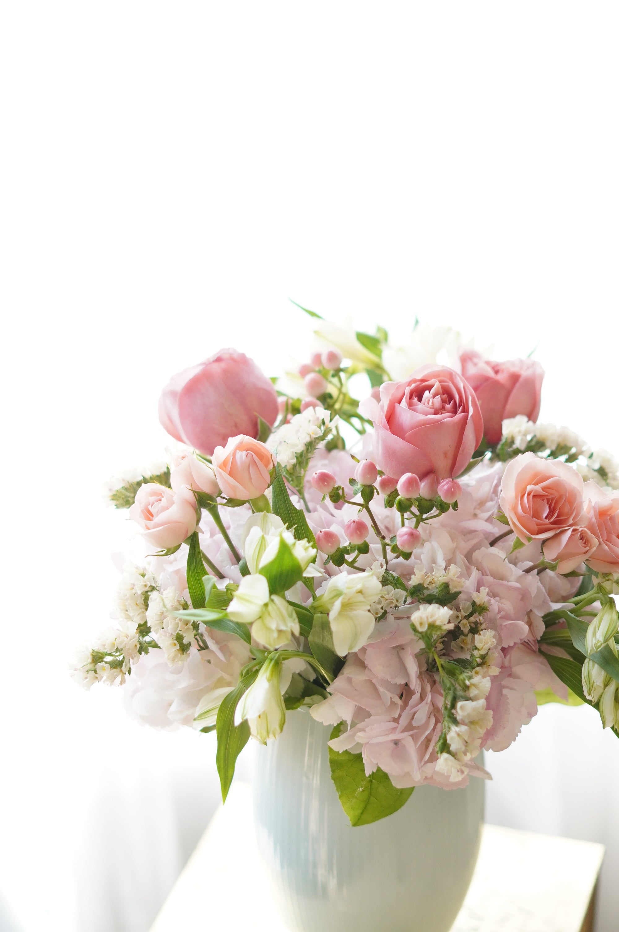 Bouquet of pink and white flowers on a white background