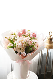 Bouquet of flowers in a decorative box with a soft white background