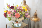 Premium floral centerpiece with peach roses and delicate wildflowers – Moon’s Flowers