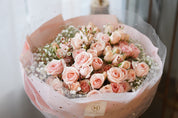 Close-up of delicate pink spray roses and baby’s breath bouquet with soft romantic details