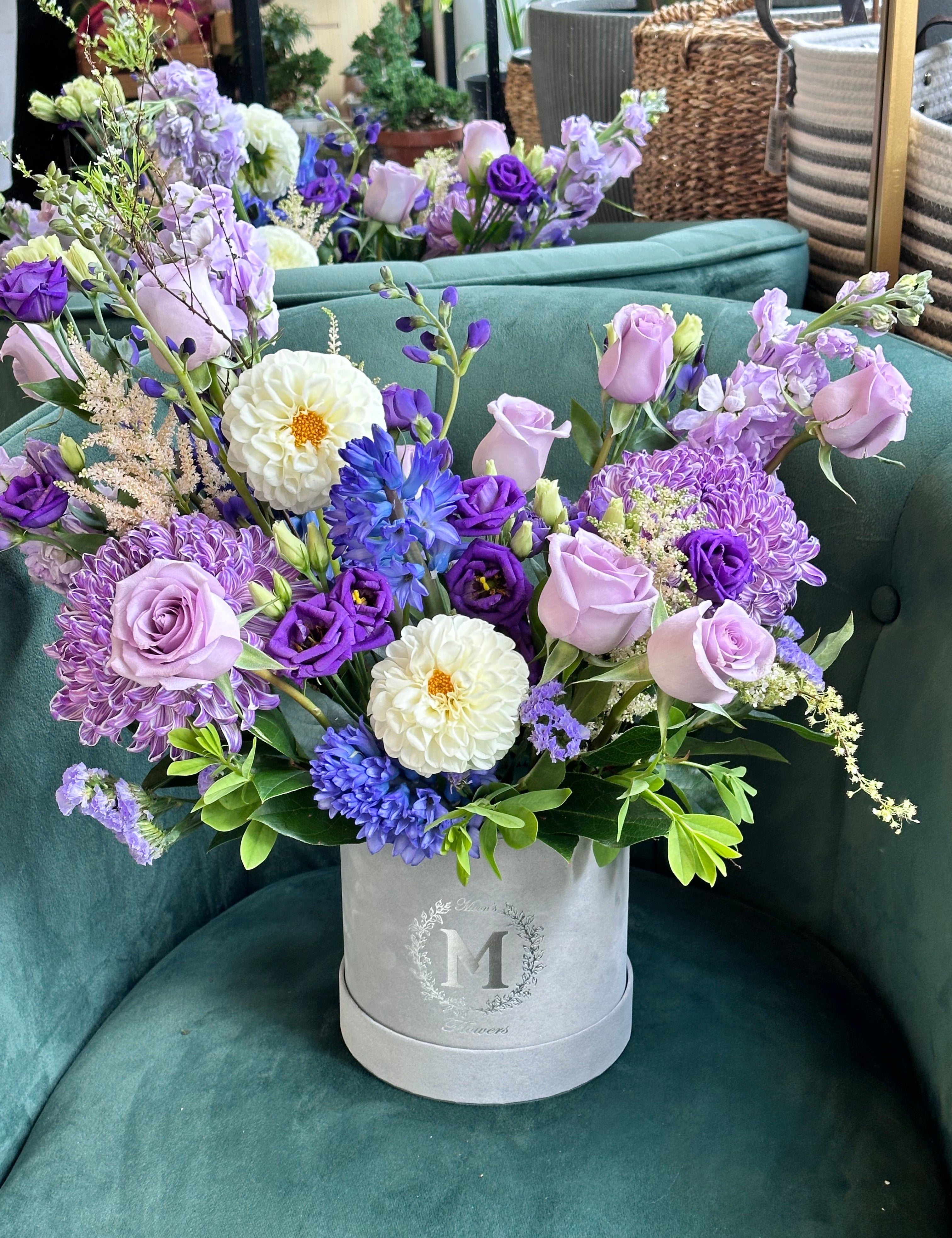 Purple Blossom Box closeup of fresh blooms like lavender roses, lisianthus, and purple chrysanthemums
