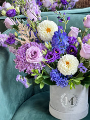 Close up of Purple Blossom Box,  a purple arrangement by Moon's Flowers a flower store in Toronto.