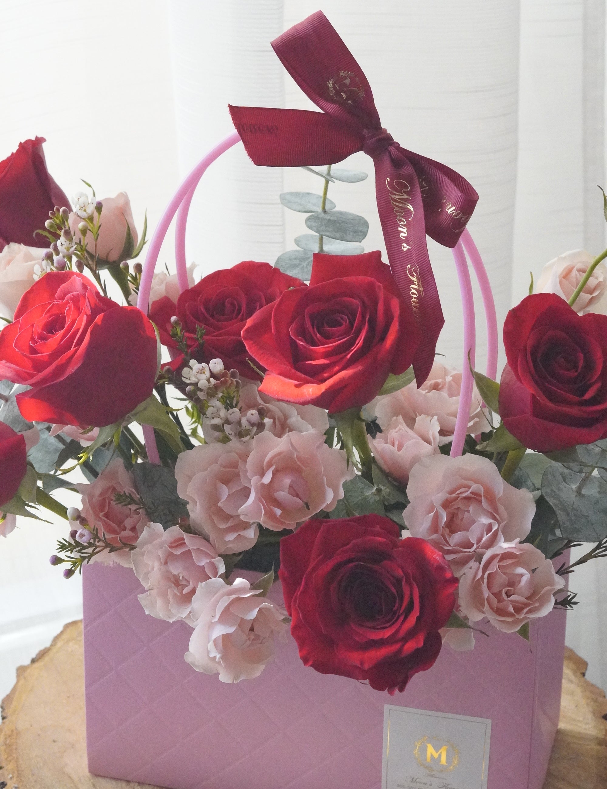 Close-up of red and blush roses with spray roses highlighting color contrast and floral detail