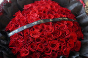 Large red rose round bouquet featuring approximately 100 roses with a luxurious dome shape

