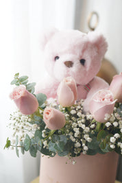 Romantic pink rose box with teddy bear in elegant pastel design
