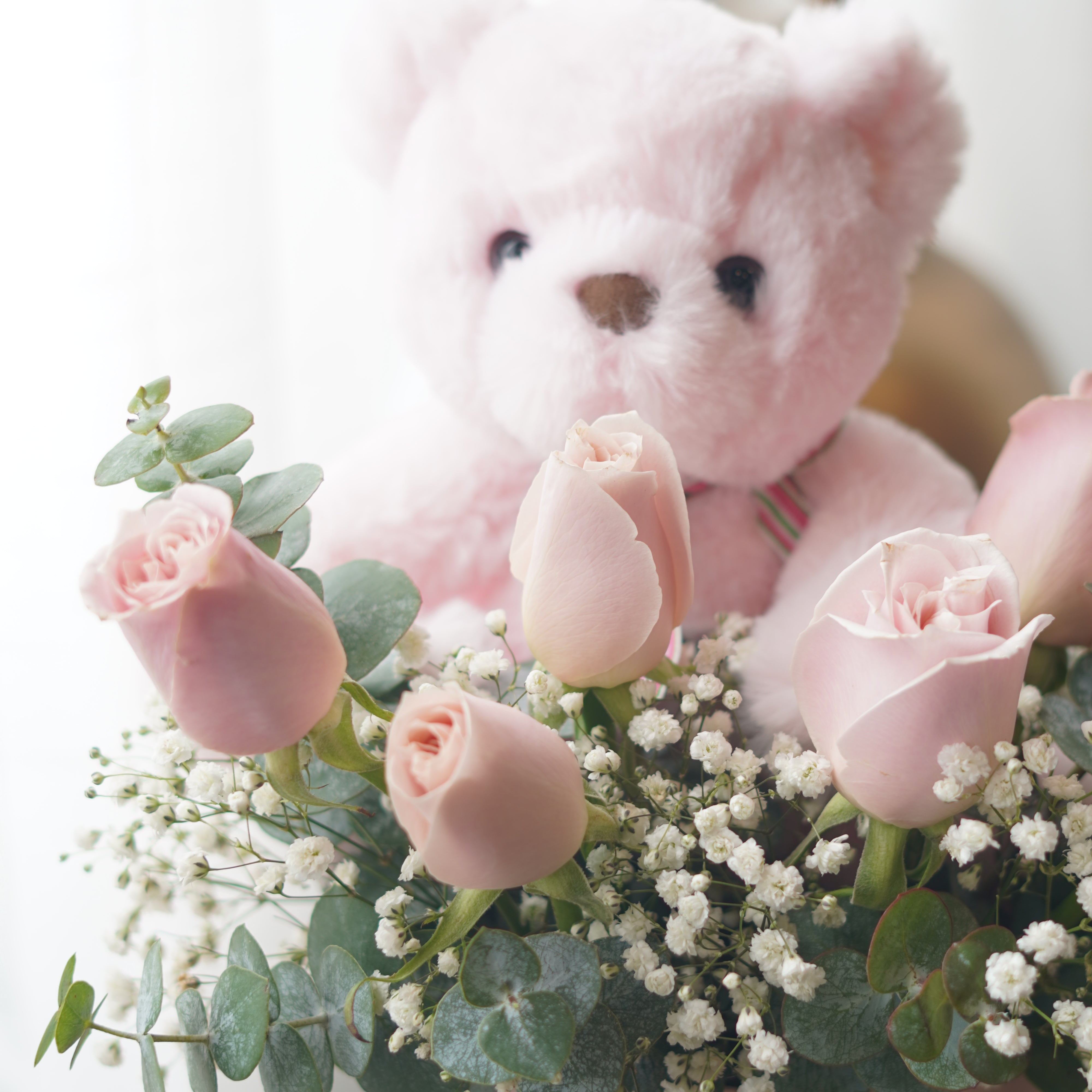 Romantic pink rose box with teddy bear in elegant pastel design
