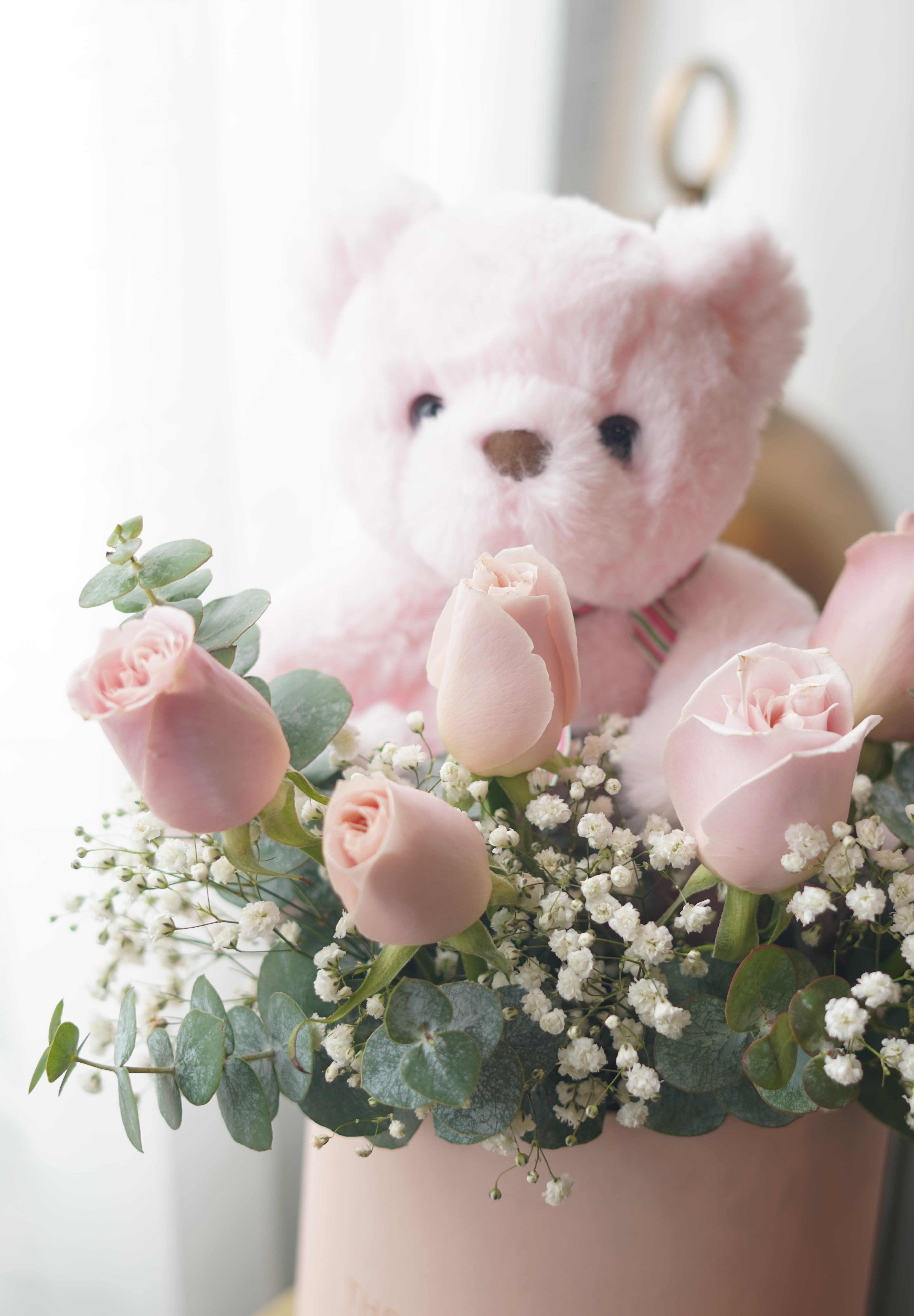 Romantic pink rose box with teddy bear in elegant pastel design
