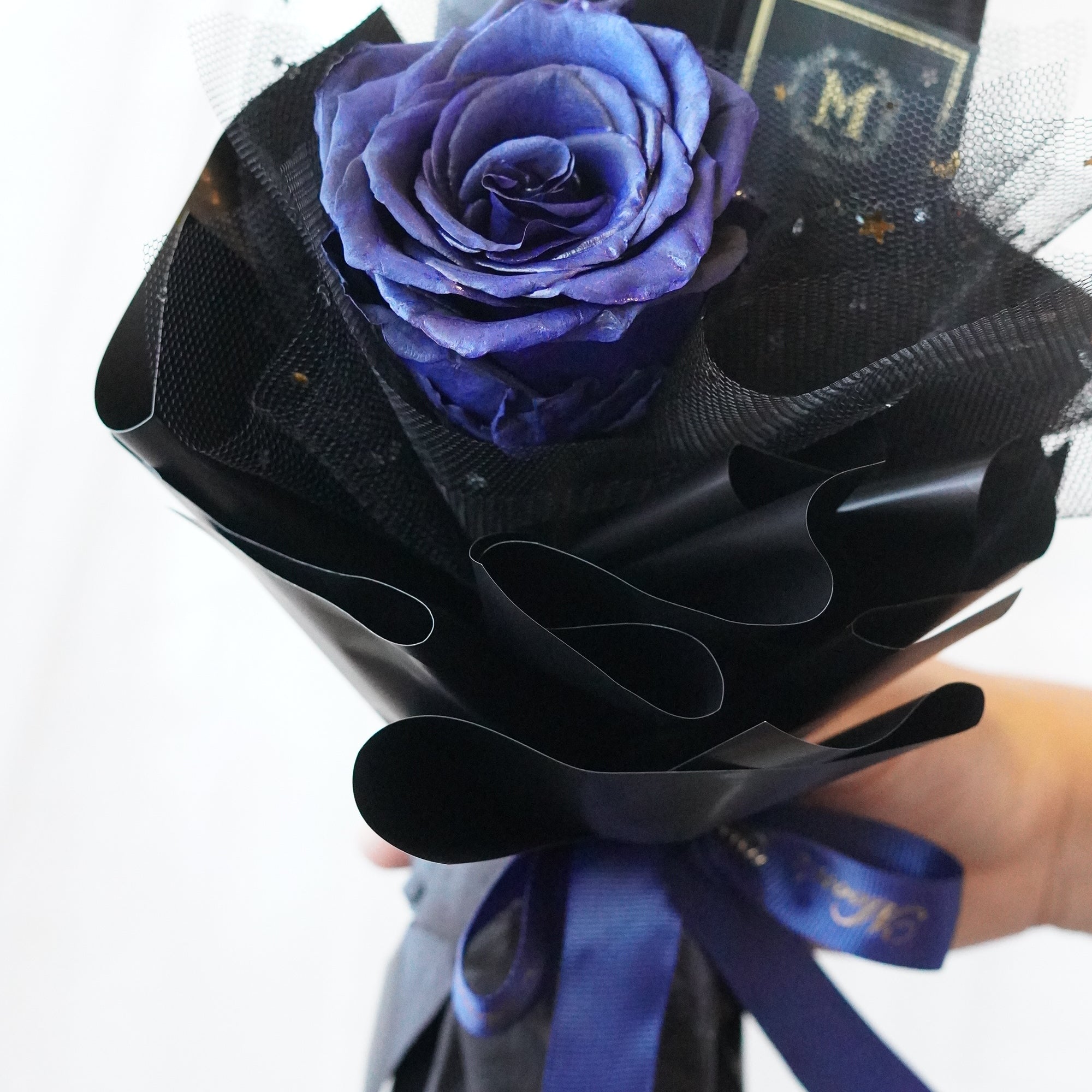 Close-up of a fresh long stem rose showcasing petal detail and elegant wrapping