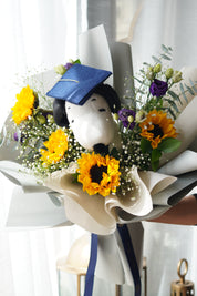 Snoopy graduation bouquet with sunflowers, baby’s breath, and purple flowers, hand-held bouquet