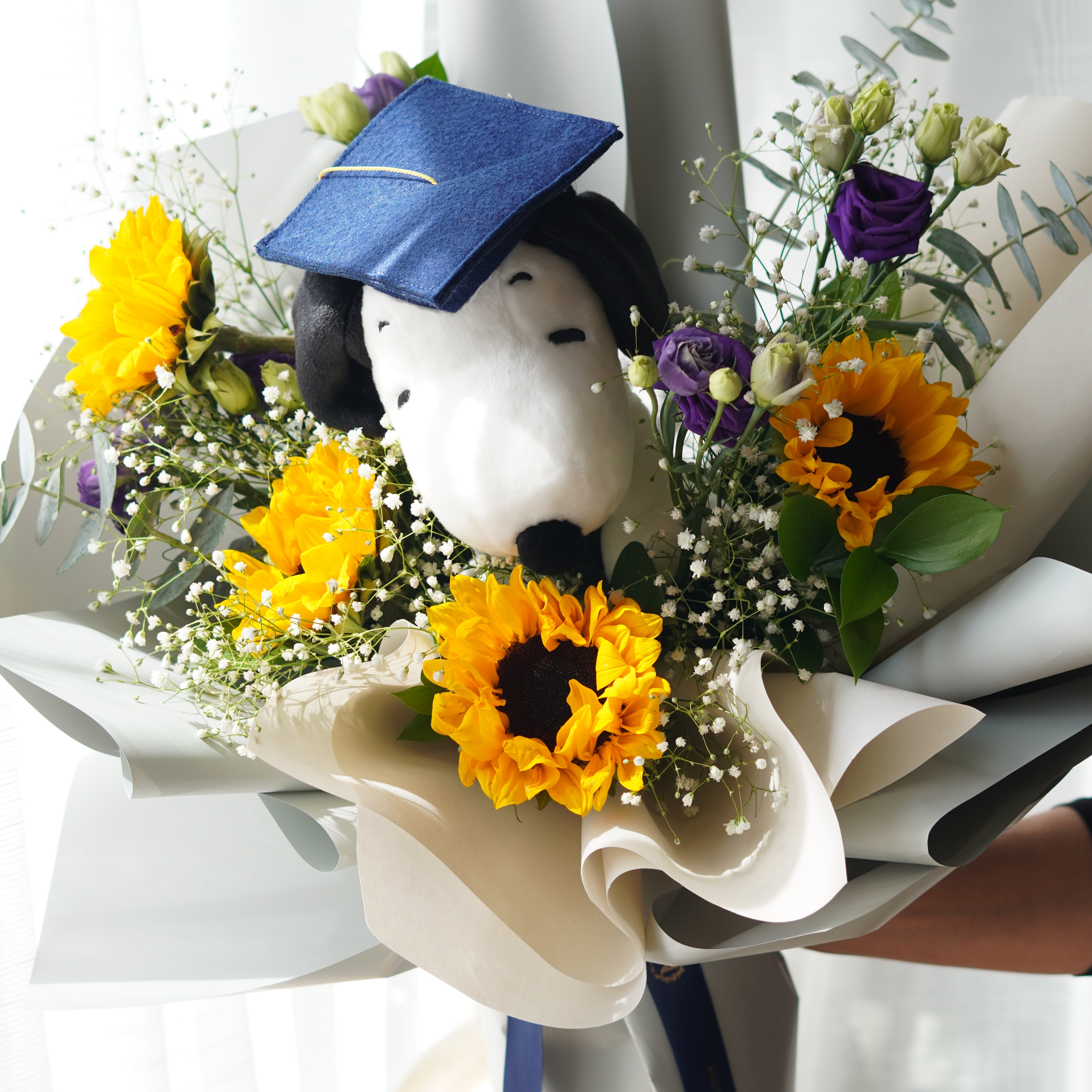 Snoopy graduation bouquet with sunflowers, baby’s breath, and purple flowers, hand-held bouquet