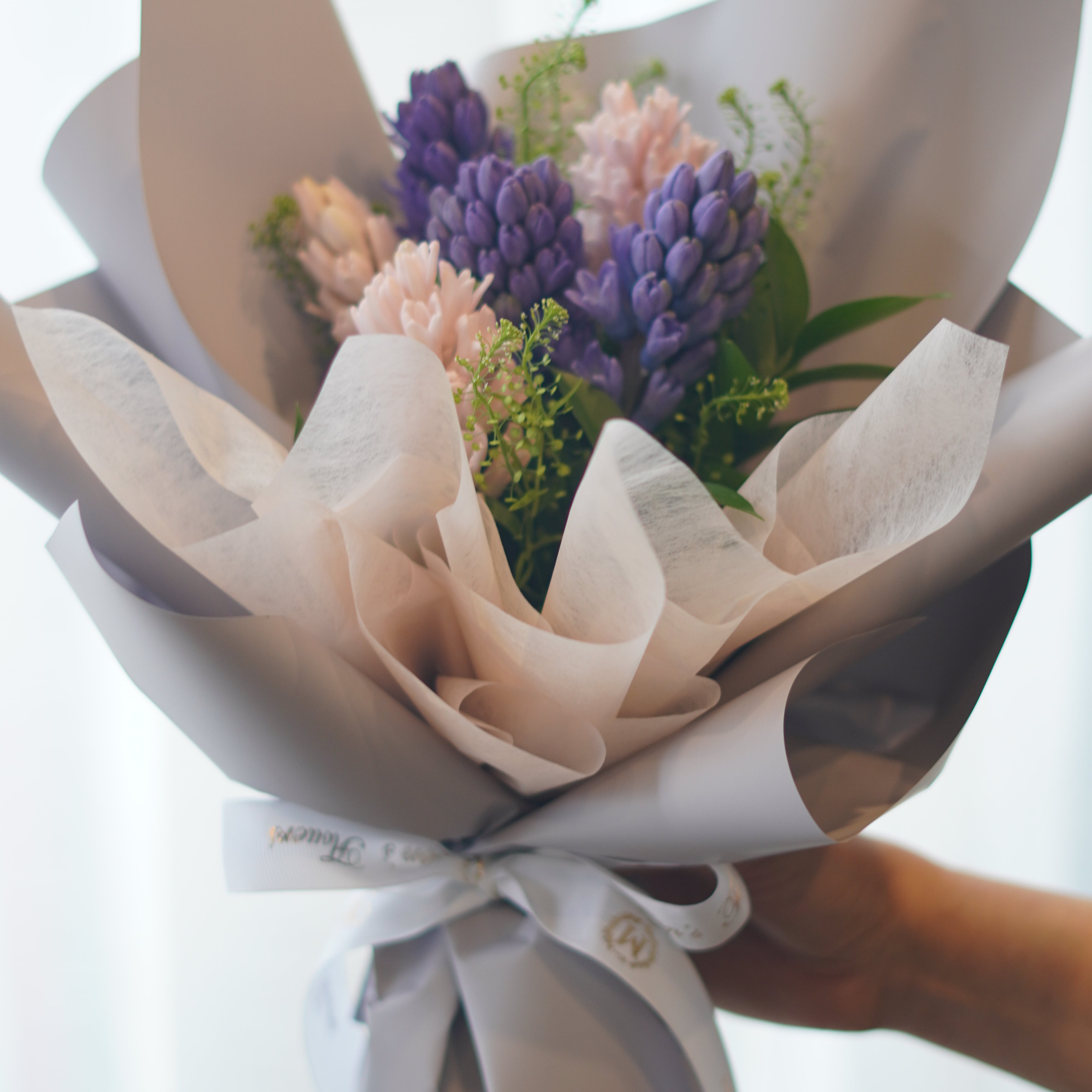 Spring hyacinth bouquet with blush tones and soft wrapping