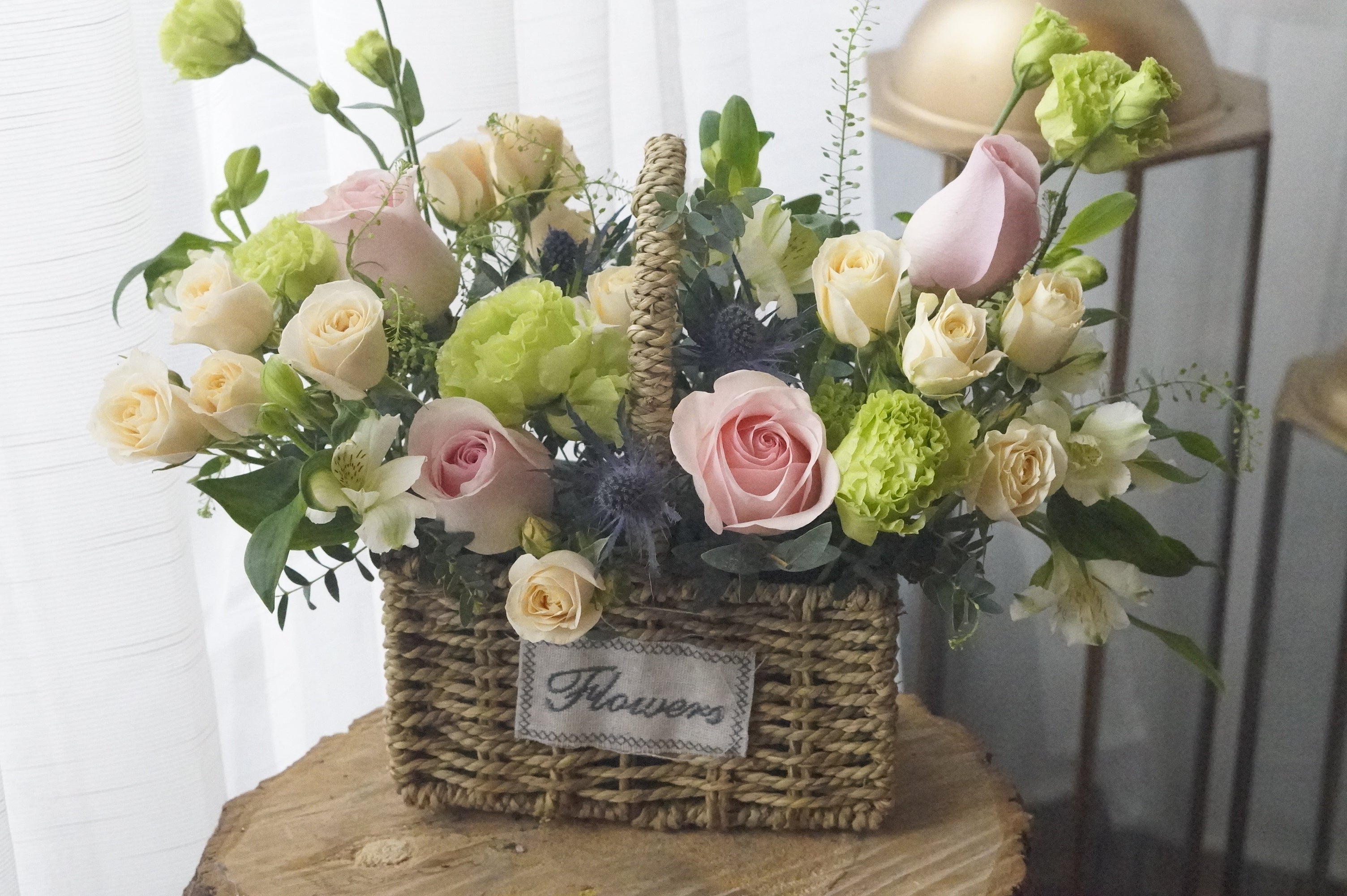 Spring in a Basket is unique as it uses a basket as the vase to hold the flowers, making it a homey and special gift.