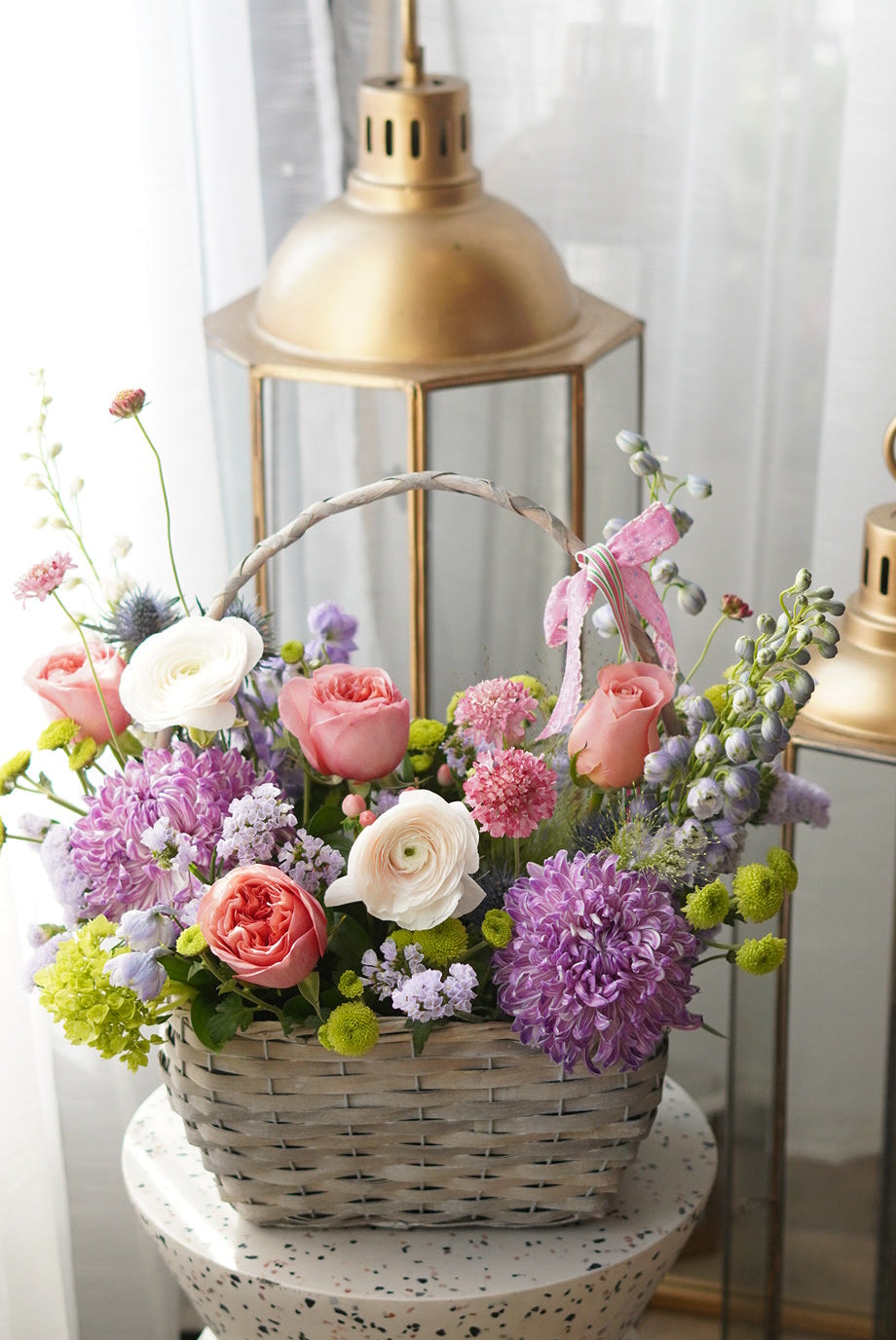 pastel flower basket arrangement with roses, ranunculus and hydrangea in white woven basket Toronto