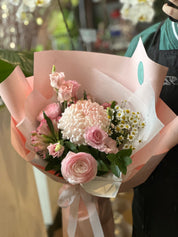 Closeup of Summer Fairy that has chamoille, pink chrysanthemum, ranunculus, spray roses and alstormeria