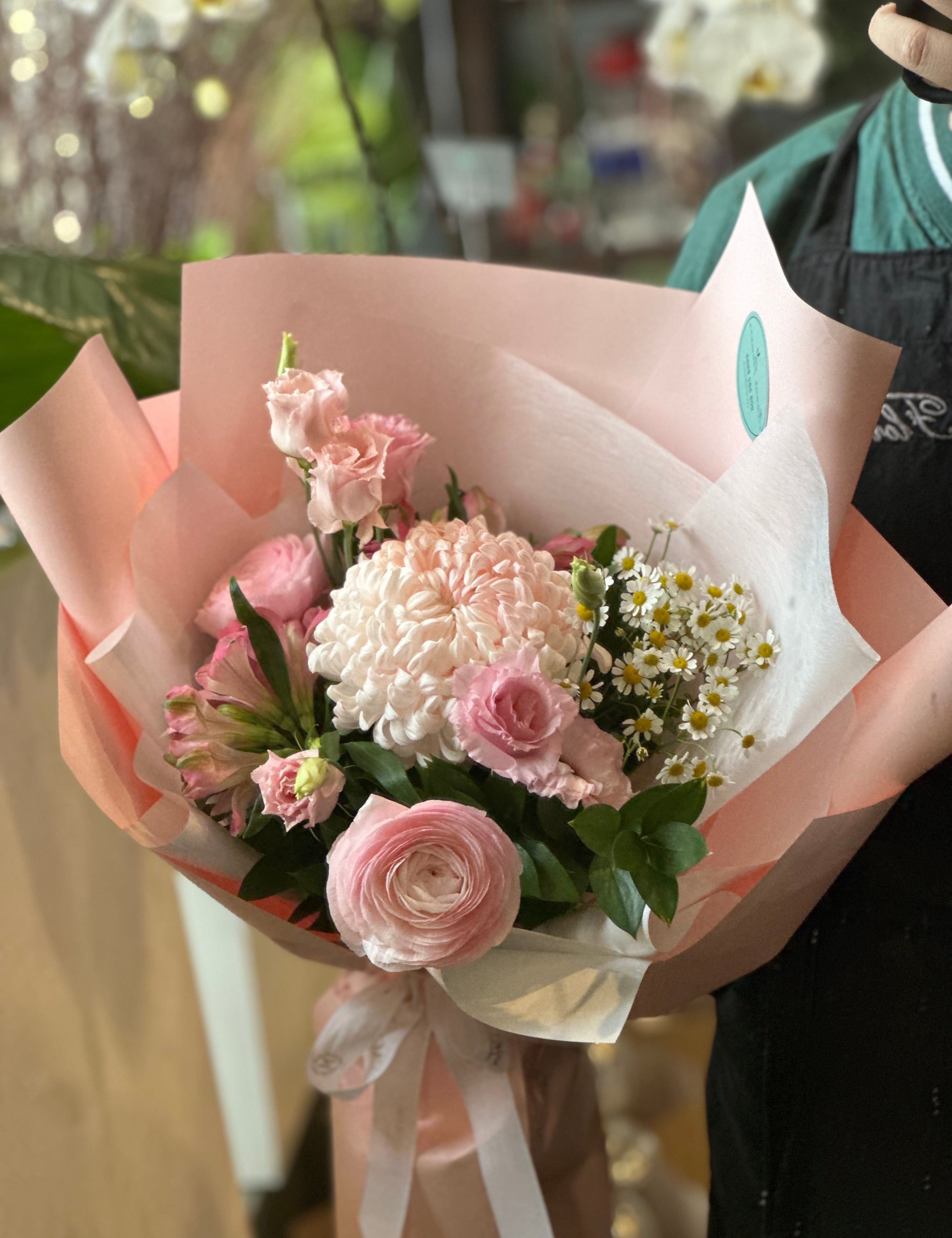 Closeup of Summer Fairy that has chamoille, pink chrysanthemum, ranunculus, spray roses and alstormeria